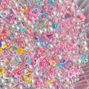 Mixed DIY resin charms, clear acrylic rhinestones and faux pearl beads for craft making.