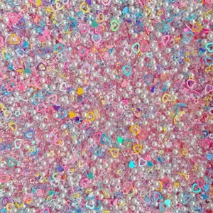 Mixed DIY craft beads, pearls, rhinestones, and iridescent heart sequins for cream glue cases.