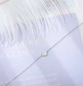 S925 sterling silver heart anklet detail shot, minimalist design, elegant and sweet style.