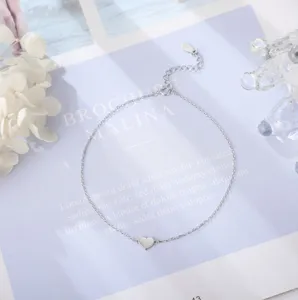 Delicate silver heart anklet detail shot, minimalist design, perfect for elegant daily wear.