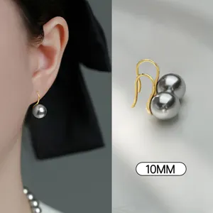Detailed close-up view of elegant grey round pearl ear hooks showcasing fine texture.