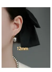 Close-up detail view of 12mm grey pearl hook earrings, elegant French luxury jewelry.