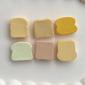 Close-up detail of colorful toast resin cabochons for DIY crafts and phone case decoration.
