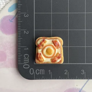 Resin fried egg toast charm detail, cute food play cabochon for DIY shoe decoration and crafts.