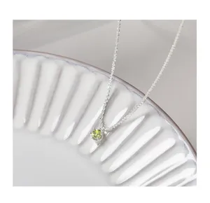 Sterling silver star chain detail shot with sparkling olive green zircon pendant necklace.
