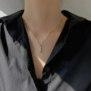 Detailed close-up view of the sterling silver bamboo pendant necklace resting on the collarbone.
