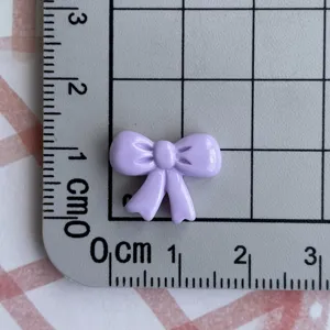 Purple resin bow DIY craft accessory, miniature flatback hair clip charm for jewelry making.