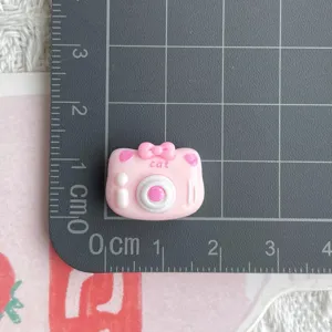 Small pink resin cat camera cabochon charm for DIY crafts, hairpins and keychains accessory.