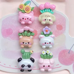 Cute cartoon animal resin cabochons detail shot, featuring floral plant pots for DIY phone cases.