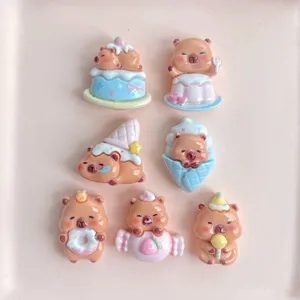 Detailed view of mini resin capybara dessert charms, cute DIY hair clip decoration items.