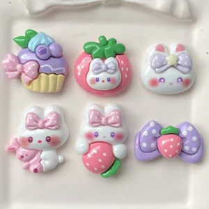 Cute resin DIY craft charms featuring pastel bunnies, strawberries, and cakes detail.