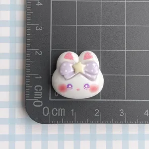 Cute white rabbit resin charm with purple bow DIY craft accessory detail close-up display.