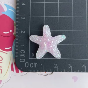 Accessoire en résine étoile de mer pailletée translucide, idéal pour les loisirs créatifs.