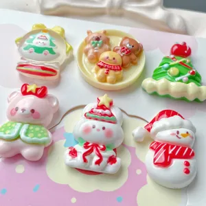 Christmas resin charms detail view with snowman and gingerbread man for DIY crafts.