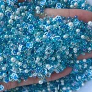 Mixed blue bubble beads and cute cat paw charms for DIY slime and handmade jewelry making details.