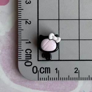 Mini black pink resin charm detail view, cute bow cartoon accessory for DIY crafts and phone cases.