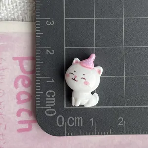 Resin cat figurine detail, pink party hat, miniature DIY craft accessory for decoration.