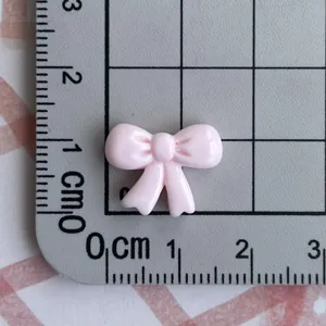 Mini pink resin bowknot DIY accessory for earrings, nail art, keychains, and hairpins material.