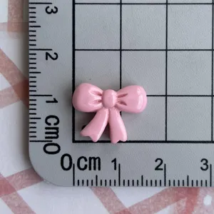 Mini pink bow resin charm for DIY nail art, earrings, keychains, and hair clip accessories.