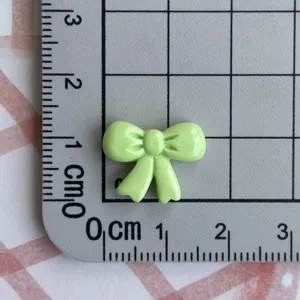 Mini light green resin bowknot charm for DIY nail art jewelry hair clip making.