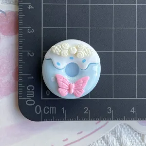 Cute blue donut resin charm with pink bow detail, perfect for DIY phone case and hairpin crafts.