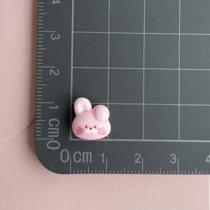 Resin pink rabbit head cabochon detail view, perfect for handmade nail art and DIY crafts.