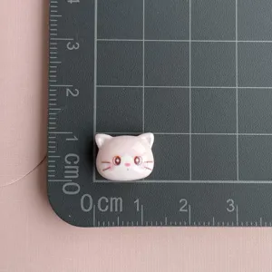 Mini pink cat resin cabochon for DIY nail art, cute animal head charm for handmade jewelry crafts.