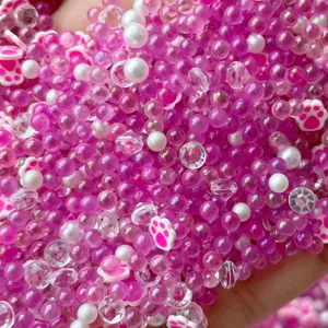 Mixed clay cat paw beads, bubble pearls and crystal charms for DIY handmade slime accessories.