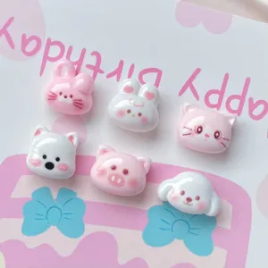 Resin cabochons close-up of cute animal resin decoration pieces for DIY nail art and hair pins.