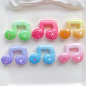 Colorful resin musical note cabochons with star glitter details, perfect for DIY phone case craft.