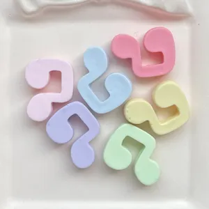 Colorful resin music note cabochons for DIY phone case and hair clip decoration details.