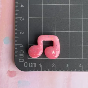Pink resin music note charm with glitter stars, perfect for DIY hair clips phone cases.