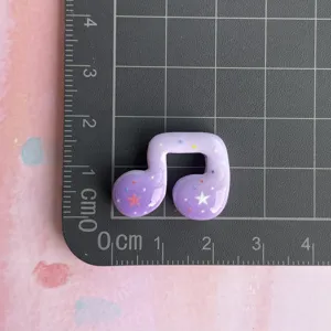 Purple music note resin charm with star glitter, DIY cabochon accessory for phone case decor.