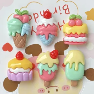 Close-up detail of cute resin ice cream cake cabochons, perfect for DIY hair clips and crafts.