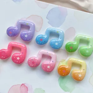 Colorful star music note resin charms detail showing sparkly glitter and smooth glossy finish.