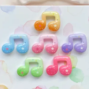 Colorful resin music note charms with cute star patterns, perfect for DIY phone case decor.