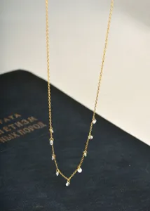 Close-up detail of the delicate gold chain necklace sparkling with lovely cubic zirconia.