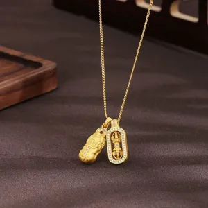 Detailed close-up of a Chinese style gold-tone Pixiu and Dorje pendant necklace, sterling silver.