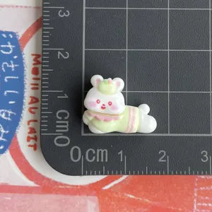 Resin rabbit charm close-up, miniature cartoon animal DIY material for phone case crafts.