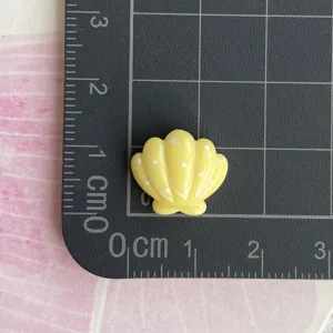 Mini yellow resin seashell charm craft accessory for phone case hairpin doll clothes diy.