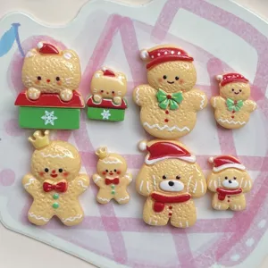 Detailed close-up of cute Christmas gingerbread man and animal resin flatback charms for DIY crafts.
