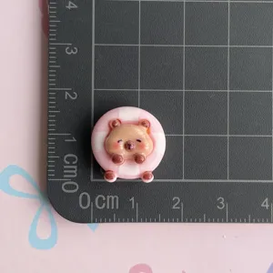 Resin capybara charm detail shot showing compact size on measurement grid mat for DIY crafts.