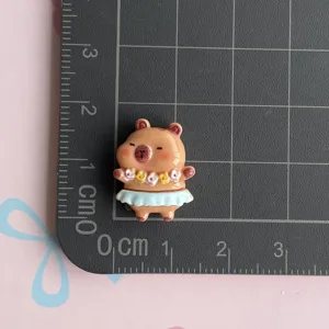 Resin capybara charm detail showing size on grid, cute DIY crafting accessory for phone case.