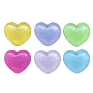 Colorful resin heart flatback cabochons with glitter for DIY phone case hair clip crafting.
