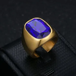Close-up of a gold-plated stainless steel men's ring featuring a large blue gemstone.