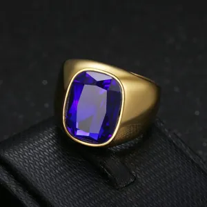 Macro view of men's gold stainless steel ring with a large blue zircon gemstone
