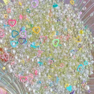 DIY mixed craft charms featuring pearls, glitter sequins, and cute hearts for crafts.