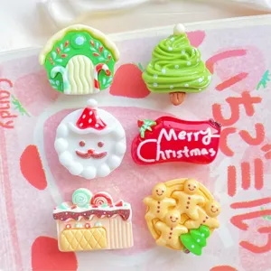Detailed view of cute Christmas resin flatbacks including gingerbread men and mini trees for DIY craft.