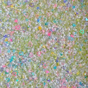 Mixed DIY resin beads, pearls, rhinestones, and heart sequins for cream glue craft.