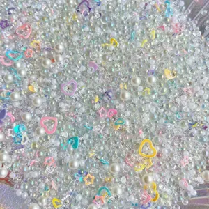 Mixed DIY craft beads, pearls, rhinestones, and resin charms for slime and phone case decor.